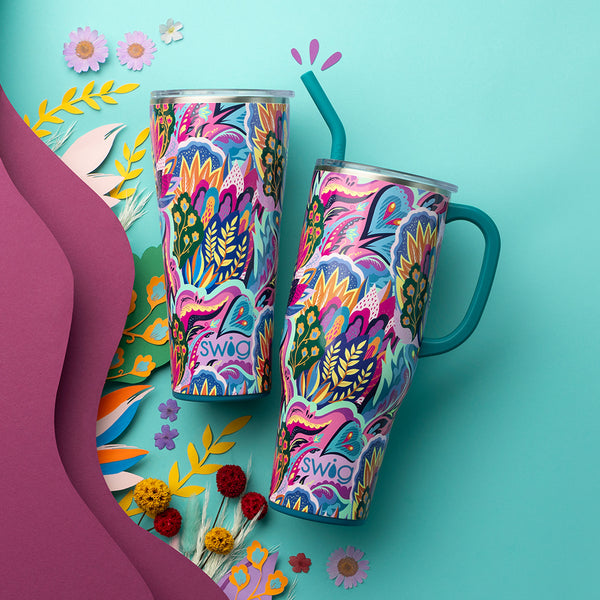 Swig Life Insulated Bazaar 32oz Tumbler and 40oz Mega Mug on a blue background with colorful floral decor