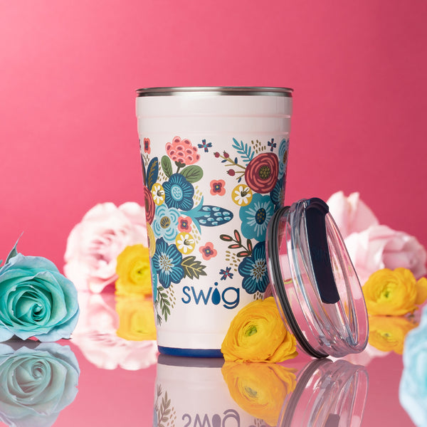 Swig Life Bella Rosa 24oz Insulated Party Cup on a pink background with flowers