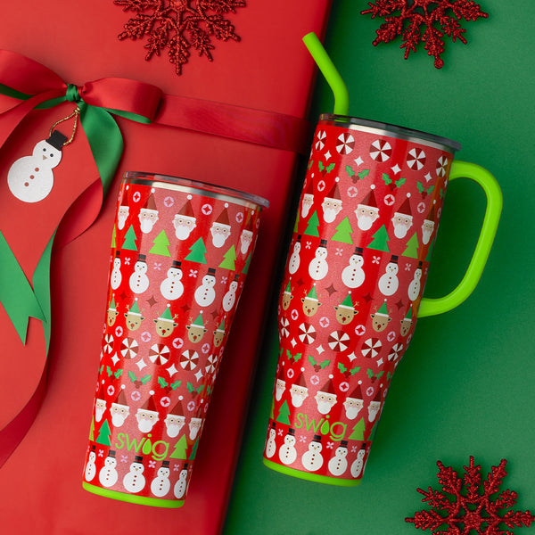 Swig Life Christmas Crew Insulated 40oz Mega Mug and 32oz Tumbler on gift wrapped present with snowflakes