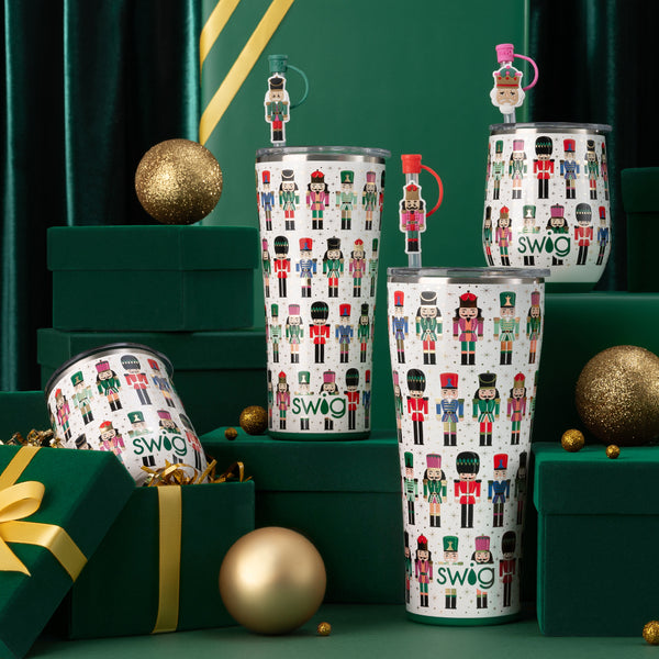 Swig Life Classic Nutcracker Insulated drinkware collection on a green holiday background