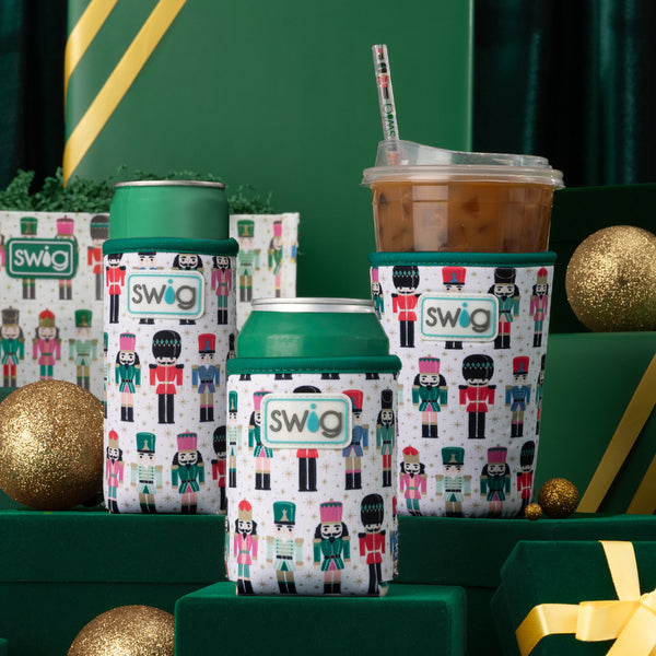 Swig Life Classic Nutcracker Insulated Neoprene Drink Coolies on a green and gold holiday background