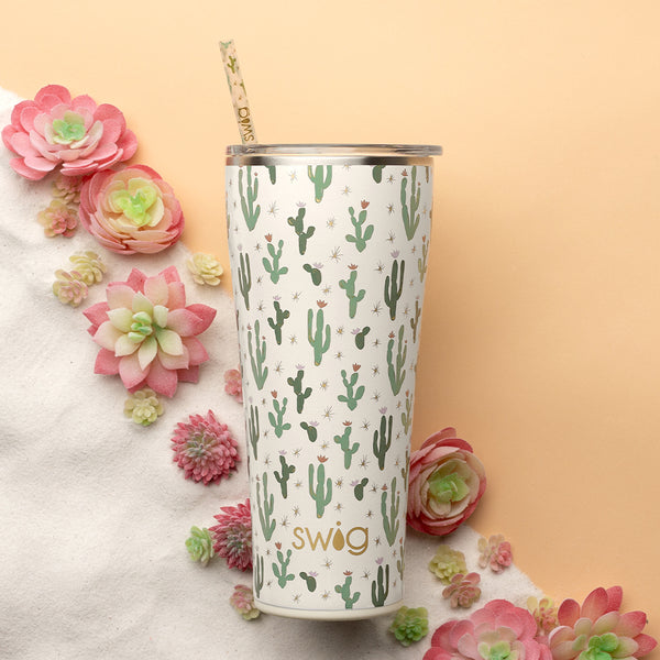 Swig Life Insulated Desert Child 32oz Tumbler on a sandy background with succulents