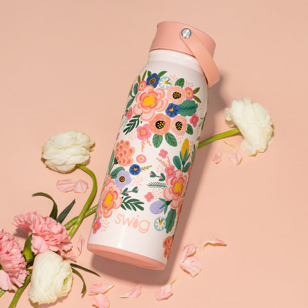 Swig Life Insulated Full Bloom 36oz Flip + Sip Bottle on a pink background with flowers