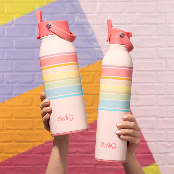 Swig Life Good Vibrations Insulated Flip + Sip Cap Water Bottles in 26oz and 36oz sizes on a colorful mural background