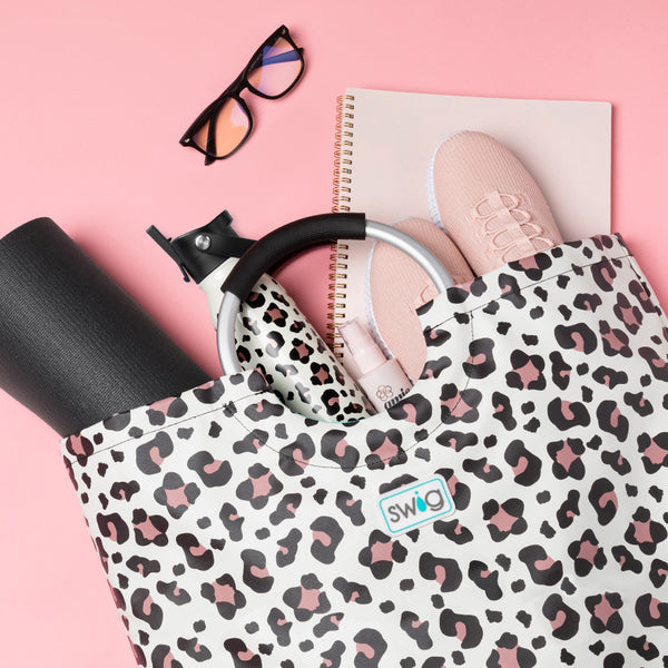 Swig Life Luxy Leopard Loopi Tote Bag with handles filled with tennis shoe, a yoga mat, Flip + Sip Water Bottle, and other essentials