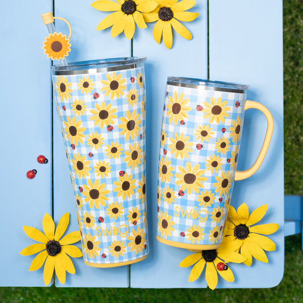 Swig Life Picnic Basket XL Set over a picnic table with yellow flowers