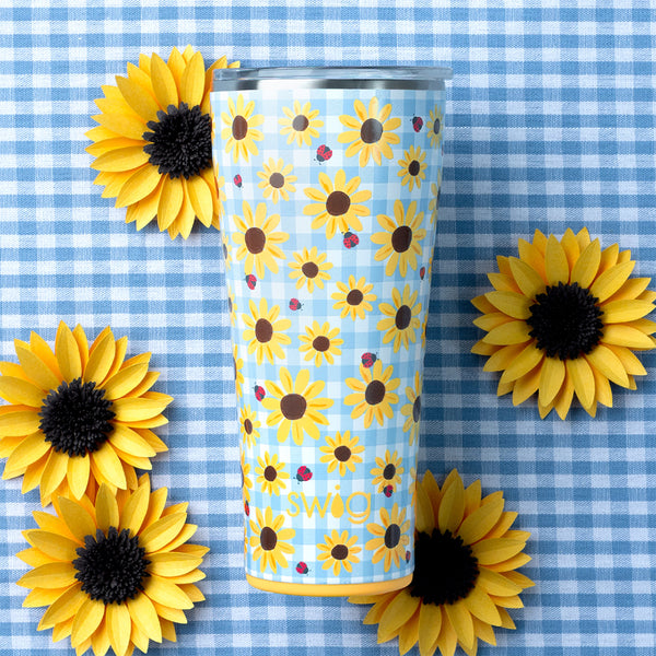 Swig Life 32oz Picnic Basket Insulated Tumbler on a blue gingham background with yellow flowers