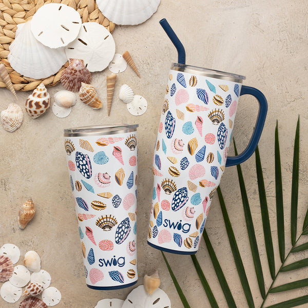 Swig Life Sea La Vie Mega Set including a 32oz Sea La Vie Tumbler and a 40oz Sea La Vie Mega Mug on a beach background