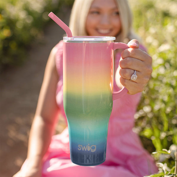 Swig Life 40oz Sunset Insulated Mega Mug being held by a smiling woman