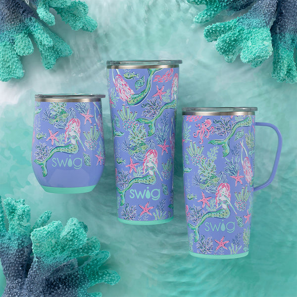 Swig Life Under the Sea Insulated 22oz Tumbler, 12oz Wine Cup, and 22oz Travel Mug on an ocean themed background