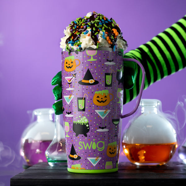 Swig Life 22oz Witches Brew Insulated Travel Mug filled with whipped cream and sprinkles