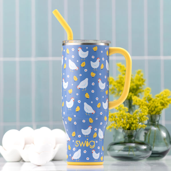 Swig Life 30oz Insulated Chicks Dig It Mega Mug on a bluet tiled background next to white eggs