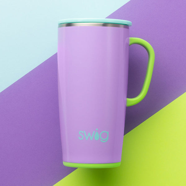 Swig Life Ultra Violet 22oz Travel Mug on a light blue, purple, and green striped background