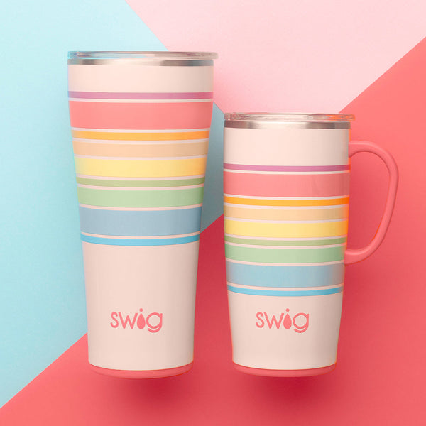 Swig Life Good Vibrations 22oz Travel Mug and 32oz Tumbler on a blue, pink, and coral geometric background