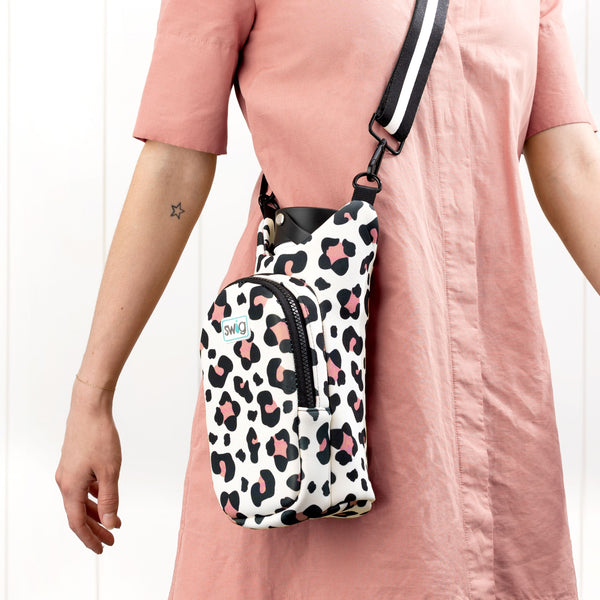 Woman wearing Swig Life Luxy Leopard Neoprene Water Bottle Sling using the shoulder strap