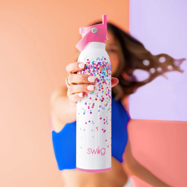 Women in blue shirt holding out Swig Life 20oz Confetti Flip + Sip Bottle